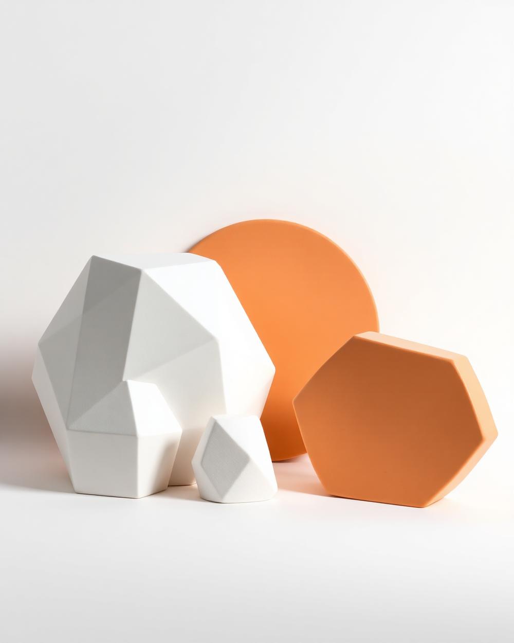 Ceramic geometric forms with orange accents